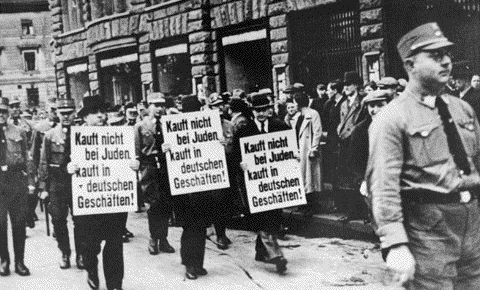 Jewish businessmen are forced to march on Bruehl Strasse, one of the main commercial streets in central Leipzig.