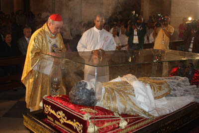 A Papist priest offers inncense to the dead body