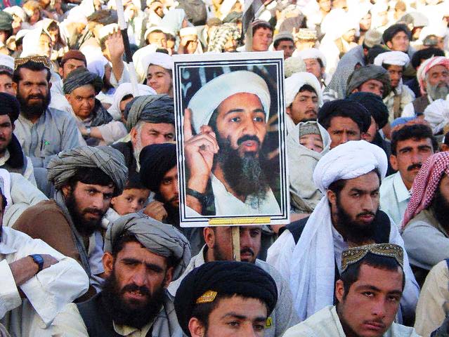 PAKISTANI ISLAMISTS HOLD A POSTER OF OSAMA BIN LADEN DURING A RALLY IN QUETTA