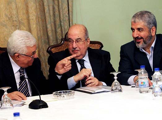 Palestinian President Mahmoud Abbas, left to right, Salim al-Zanoun, head of Palestinian national council and Hamas' supreme leader, Khaled Mashaal attend a meeting in Cairo