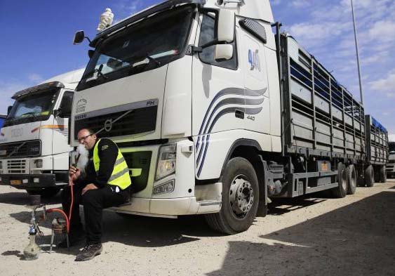 Idling Israeli truck drivers, not permitted by Hamas to drive aid into Gaza. 
