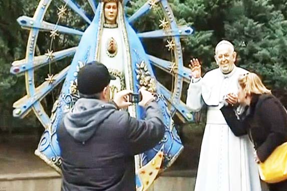 Roman Catholics caught in a moment of idolatry. 