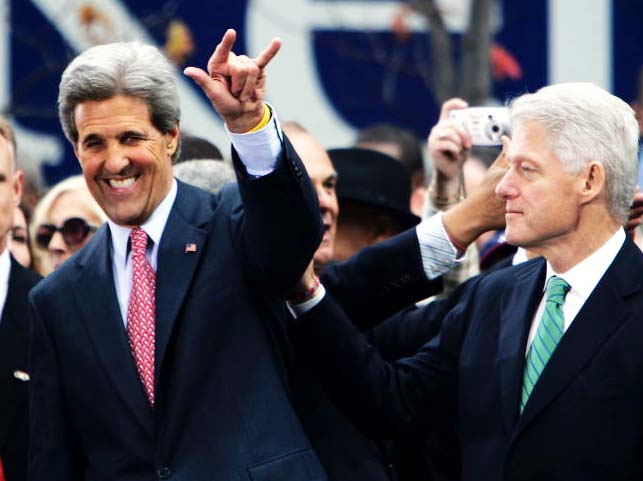 A smiling John Kerry identify and greets an Order brother in the room.