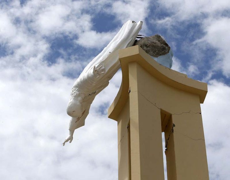 A quake-damaged statue of Jesus hangs beside the collapsed Our Lady of Light church in Loon, Bohol, on October 16, 2013.