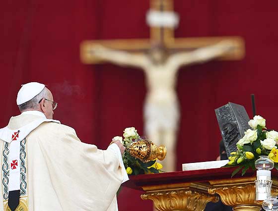 Pope Francis blesses the ashes of St Peter during a ceremony in the Vatican.  PHOTO/AFP. Behind an idol of the dead false 'Christ" of Rome.