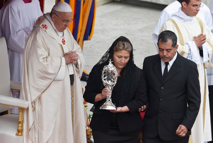Floribeth Mora Diaz carry the container with "holy blood".