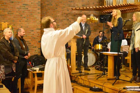 A Roman Catholic monk burn incense over singing Pentecostals.  