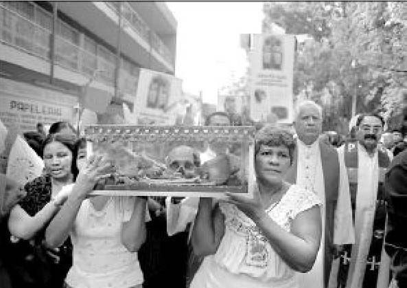 Local Mexian Catholics took on of the skulls out for a stroll. 