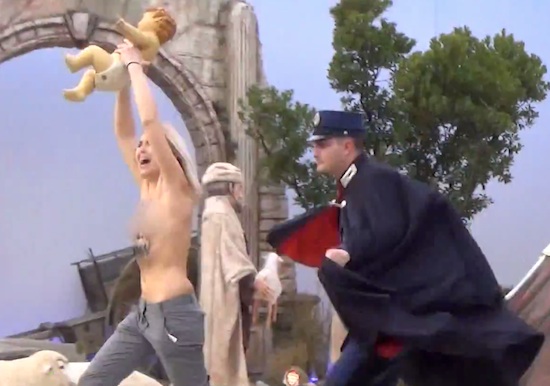 A half naked activists runs away with the Catholic copy of the Messiah. 