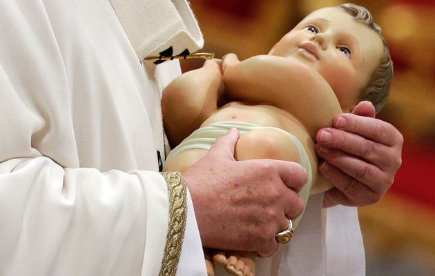 The Pope carried the plastic doll in his arms, representing a white, pale , blue eyed Italian. 