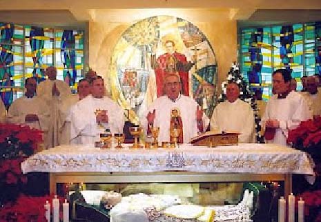 Catholic priests in the US conduct a mass with a corpse resting inside the altar. 