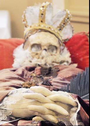 A skull is set on top of the puzzled skeleton, and fingers are made from plastic foam. 