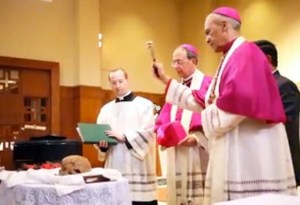 The priest blessed the skull with 