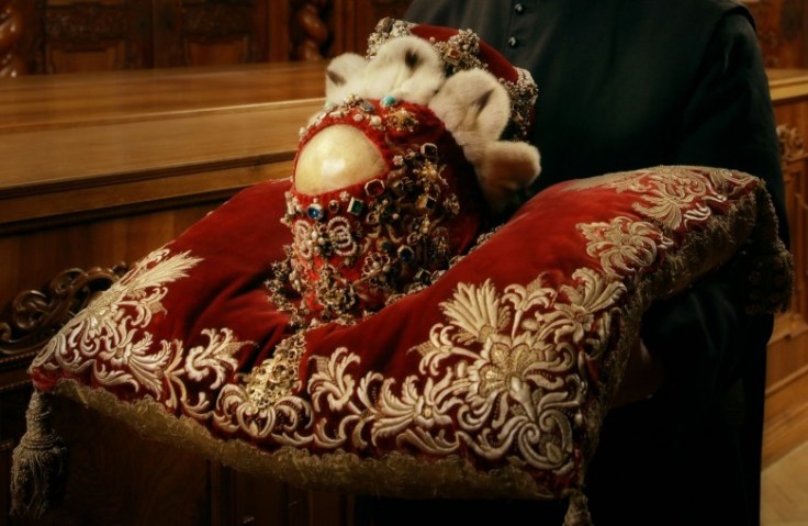 Most of the skull is covered by some garnments. 