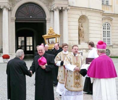 The clergy greet each other, after a walk in the sun with their 