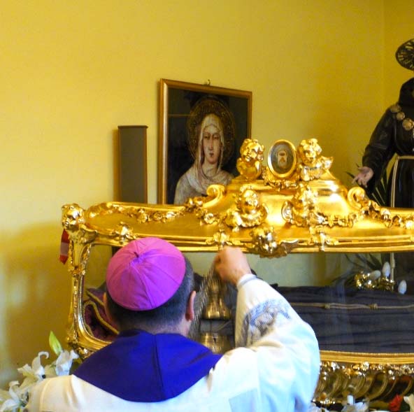 The parish priest offers insence to the dead body, in an act of worship. 