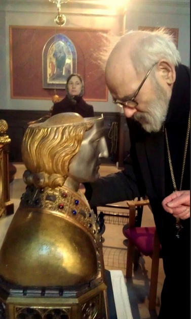 The old man bow his head before the skull, is an act of worship. 