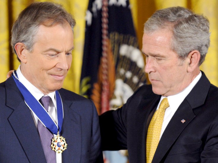 War Criminal George W. Bush gives a medal of honor to his brother in crimes. 
