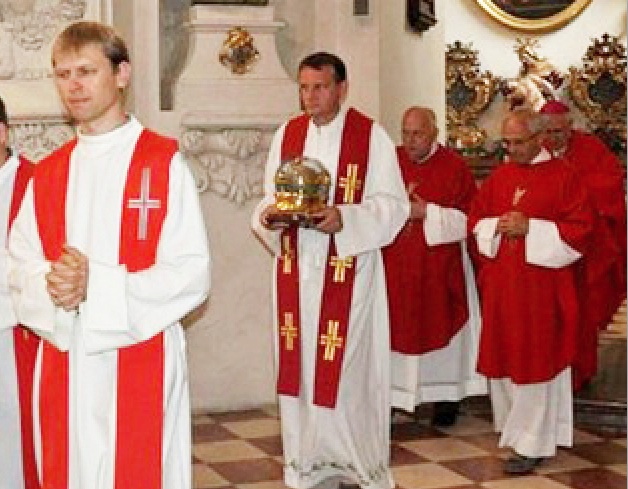 Roman Catholic priets carry the skull as they anter the Cathedral. 