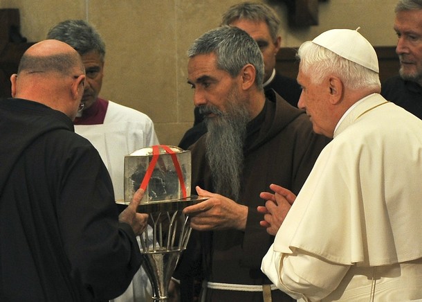 Pope Benedict XVI looks at the relics of the mystic saint Padre Pio in the crypt of Santa Maria delle Grazie in San Giovanni Rotondo