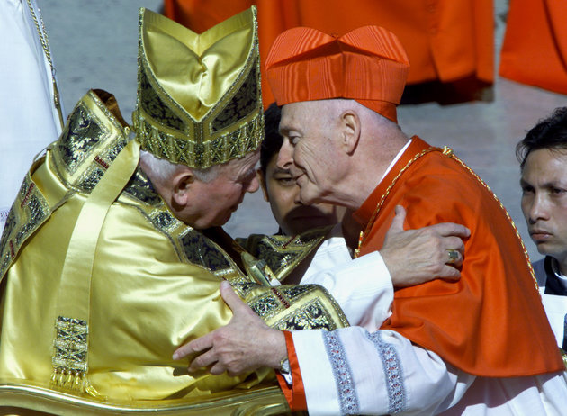America's new cardinal Theodore Edgar McCarrick kisses Pope John Paul II after he received the red b..